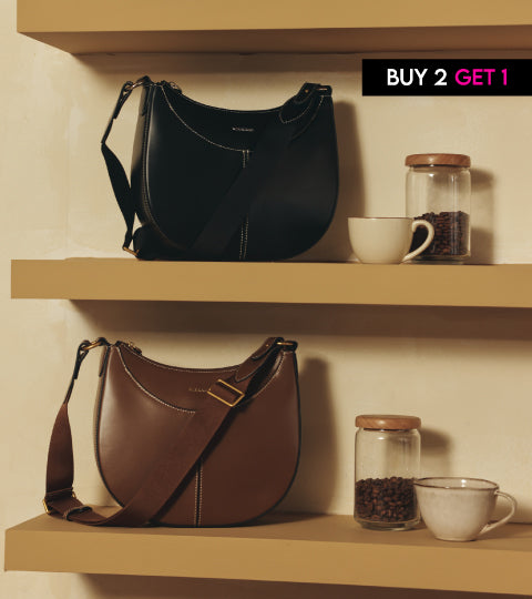 two handbags , black and brown for women on table