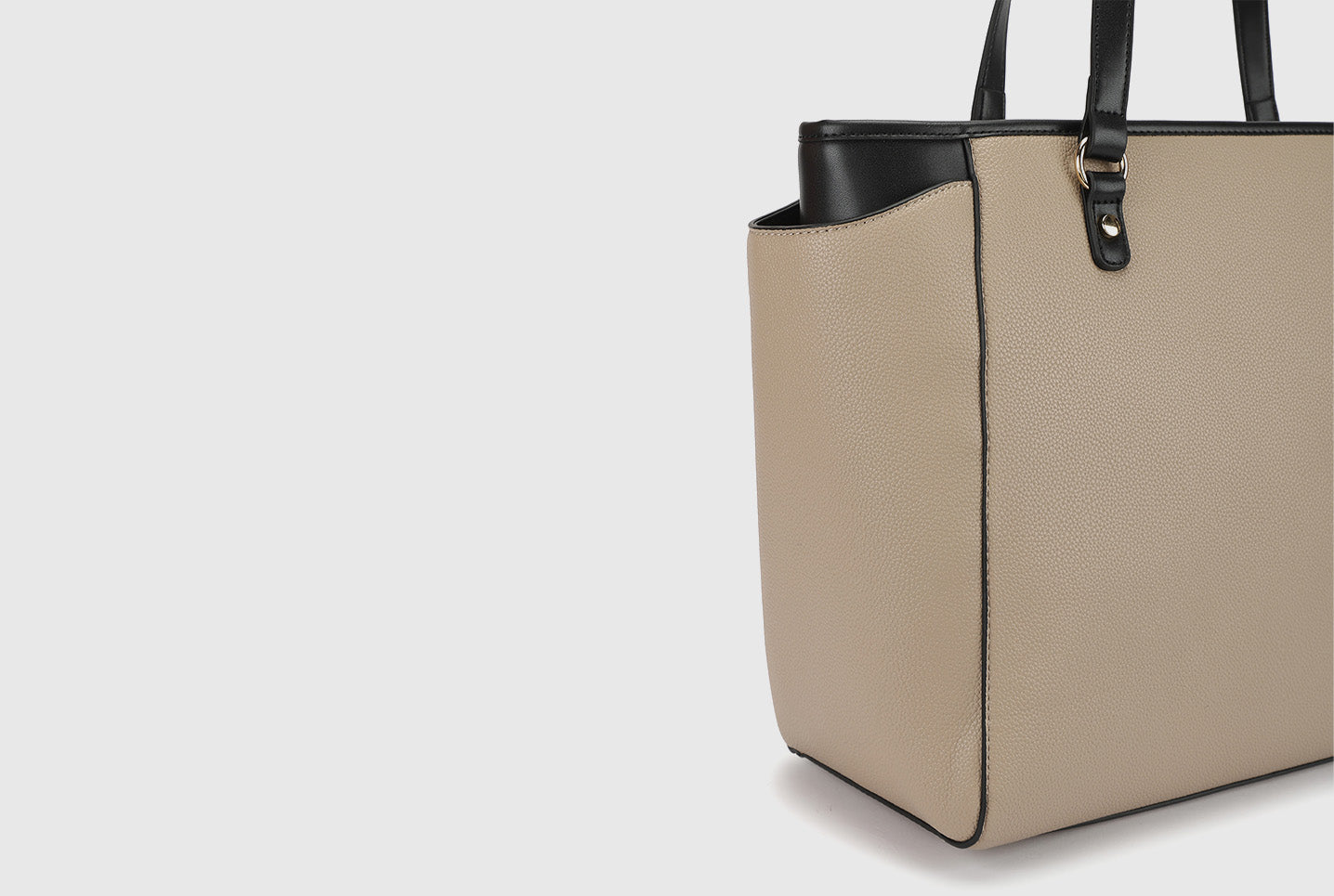 Side view of beige Miraggio tote bag with black trim and structured design.