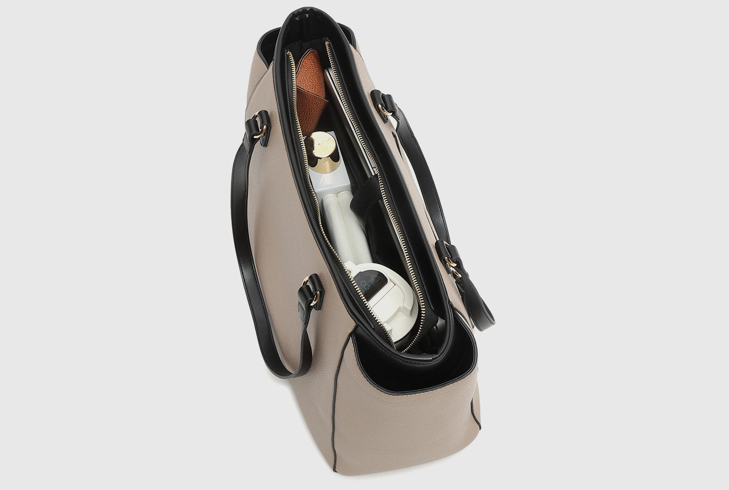 Inside view of beige tote bag showing organised compartments and stored items.