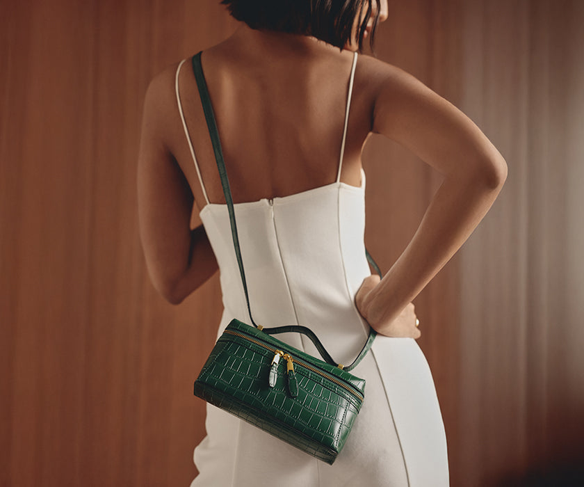 Woman carrying a best green crossbody bag from Miraggio.